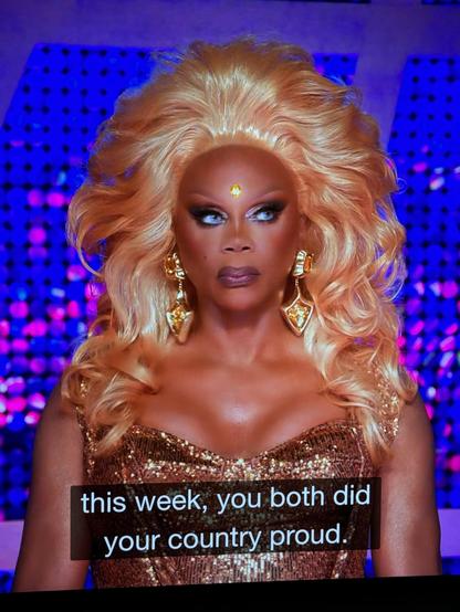 RuPaul with a yellow gem stone adorned in between her temple.