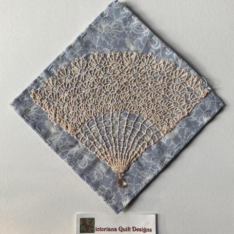 Fan quilt block made from lacy doily. 