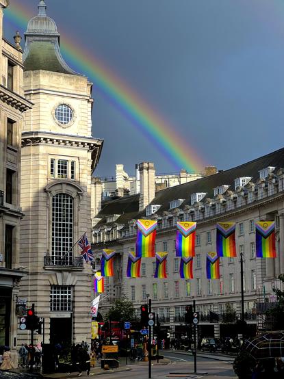 Rainbow in the sky with rainbow flags in the street