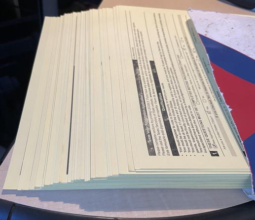Thick stack of filled out voter registration forms