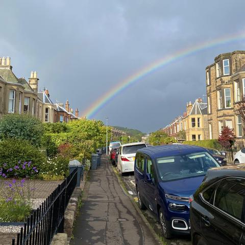 Rainbow over a street lined with terraced houses