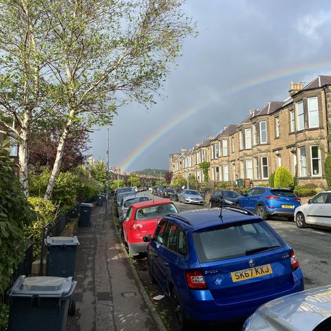 Rainbow over a street lined with terraced houses