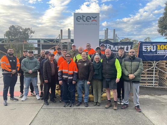 CFMEU and ETU union members assembly outside gates of ETEX 
Union banners and union clothes worn proudly.
