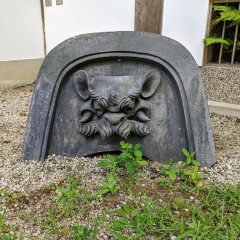 A grumpy onigawara (roof tile ornament) greets visitors to Genko-an.