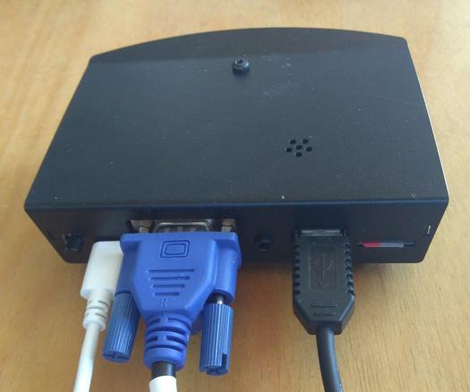 An Agon Light 2 computer with USB power, VGA, and USB keyboard cables attached