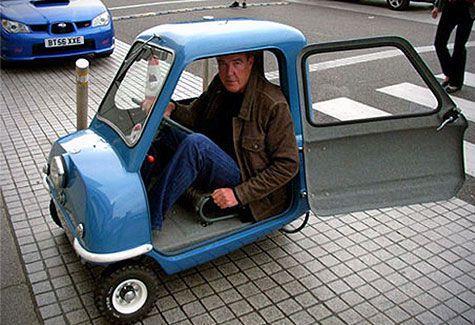 Jeremy Clarkson scrunched up in a super tiny car, no room at all for his legs