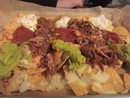 Pulled Pork Nachos with Sour Cream, Salsa and Jalapeños 