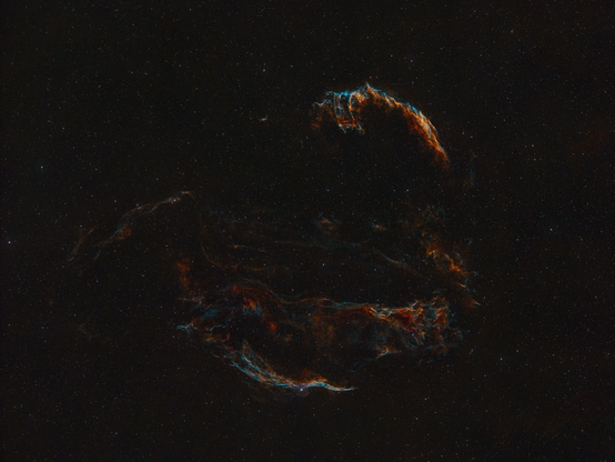 Red and blue veil like structures in the night sky