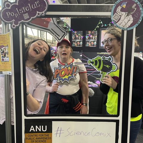 Three people with exaggerated expressions at a comic themed Photo Booth