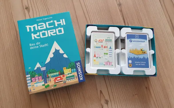 3D-printed inlay for the board game Machi Koro, showing organized cards and game components neatly arranged in the custom insert.