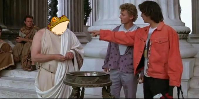 **TL;DR:** A scene from "Bill & Ted's Excellent Adventure" with a toga-wearing figure whose head has been replaced by a cartoonish frog face, as Bill and Ted point at him.

This image is a humorous edit of a scene from "Bill & Ted's Excellent Adventure." Two young men, Bill (in an orange jacket) and Ted (in a purple sweater), are standing in front of a toga-clad figure in an ancient setting with classical columns. The figure, likely a philosopher or historical figure from the movie, has had their head replaced by a large, cartoonish frog's face. The frog head is comically oversized and has a neutral expression. Bill and Ted are pointing at the figure, seemingly surprised or making a point about him. The scene takes place on steps outside a grand building with columns, adding to the historical context.