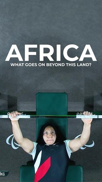 A focused image of a determined athlete performing a bench press during a powerlifting event, seen from a top-down angle. The athlete is lying on a bench, gripping a barbell with both hands, showcasing strength and concentration. Above the athlete, the text reads "AFRICA" in bold white letters, followed by the subtitle "WHAT GOES ON BEYOND THIS LAND?" against a dark background. This image highlights the spirit of African athletes in competitive sports, emphasizing their commitment and resilience.