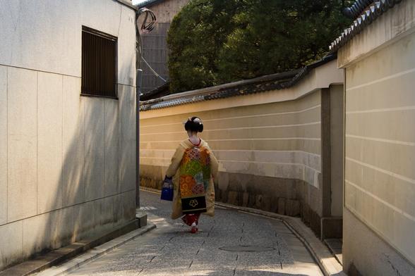 A maiko walks down the alleyways of Kamishichiken in Kyoto.