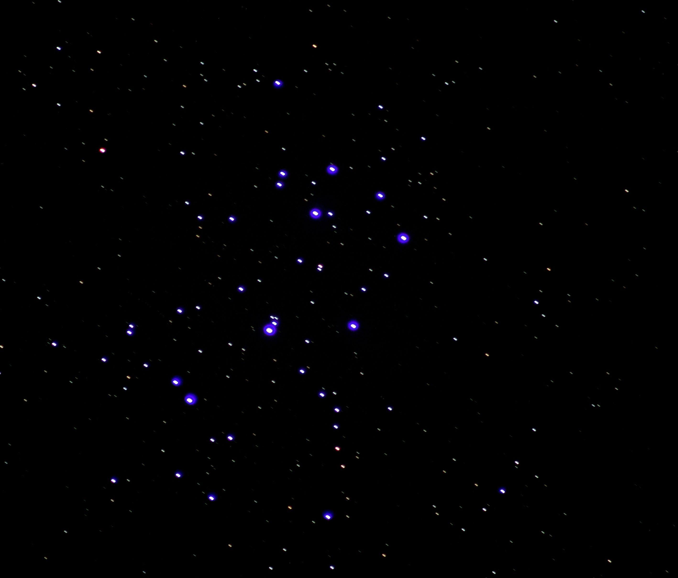 The blue Pleiades star cluster with numerous other star dots. 