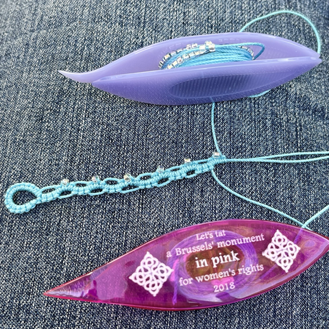 Light turquoise blue thread with silver lined seed beads with tatting shuttles attached. The beginning of a strip of tatting in the double sided chain “pearl tatting” technique.