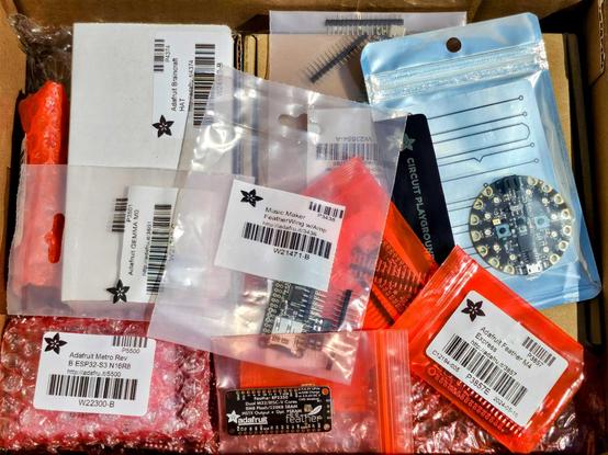 a box full of the latest dev boards from our lovely friends at Adafruit!