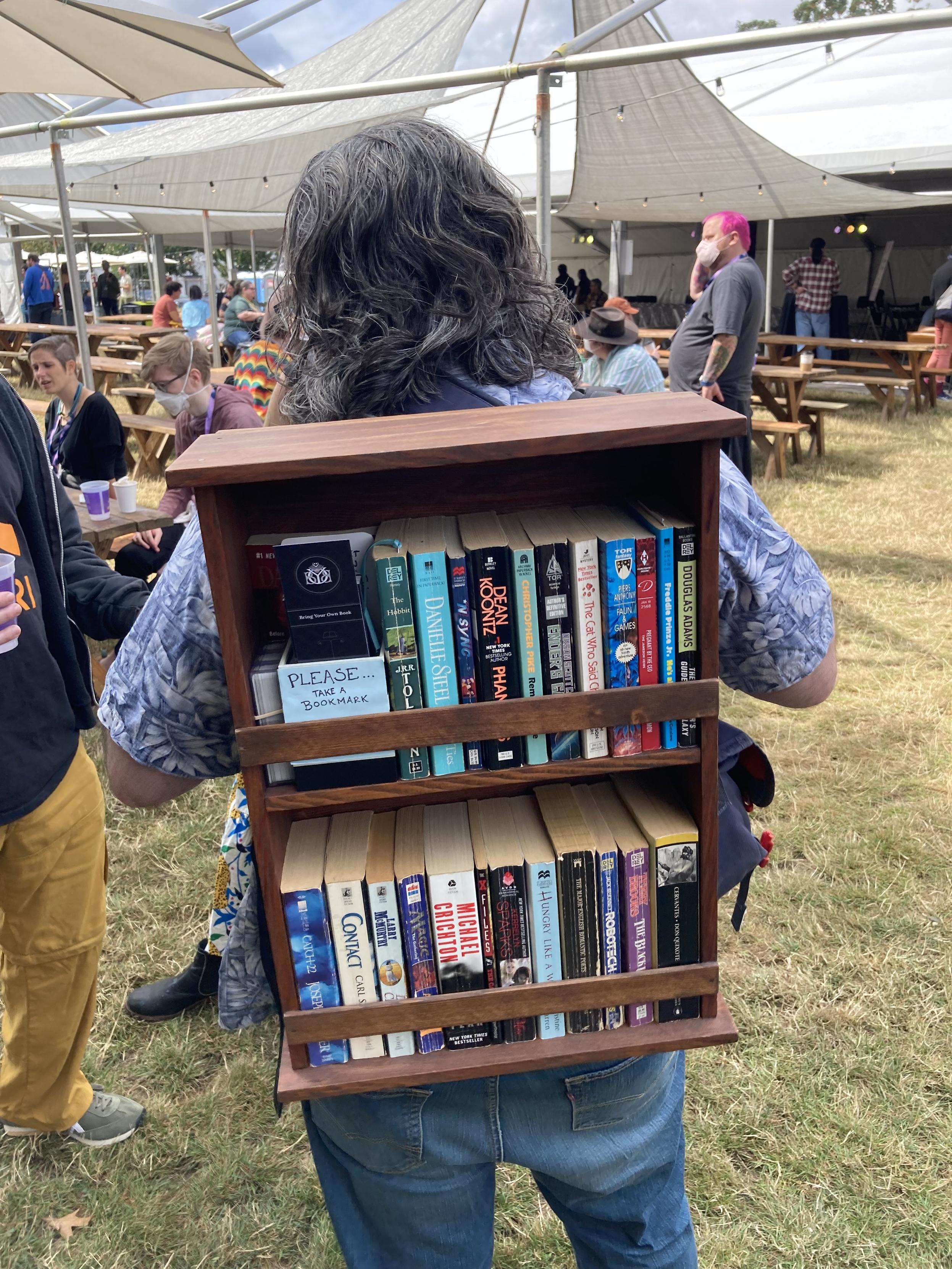 a person wearing a bookshelf backpack which is what Shrek used in the movie Shrek 3: Raiding the Stacks