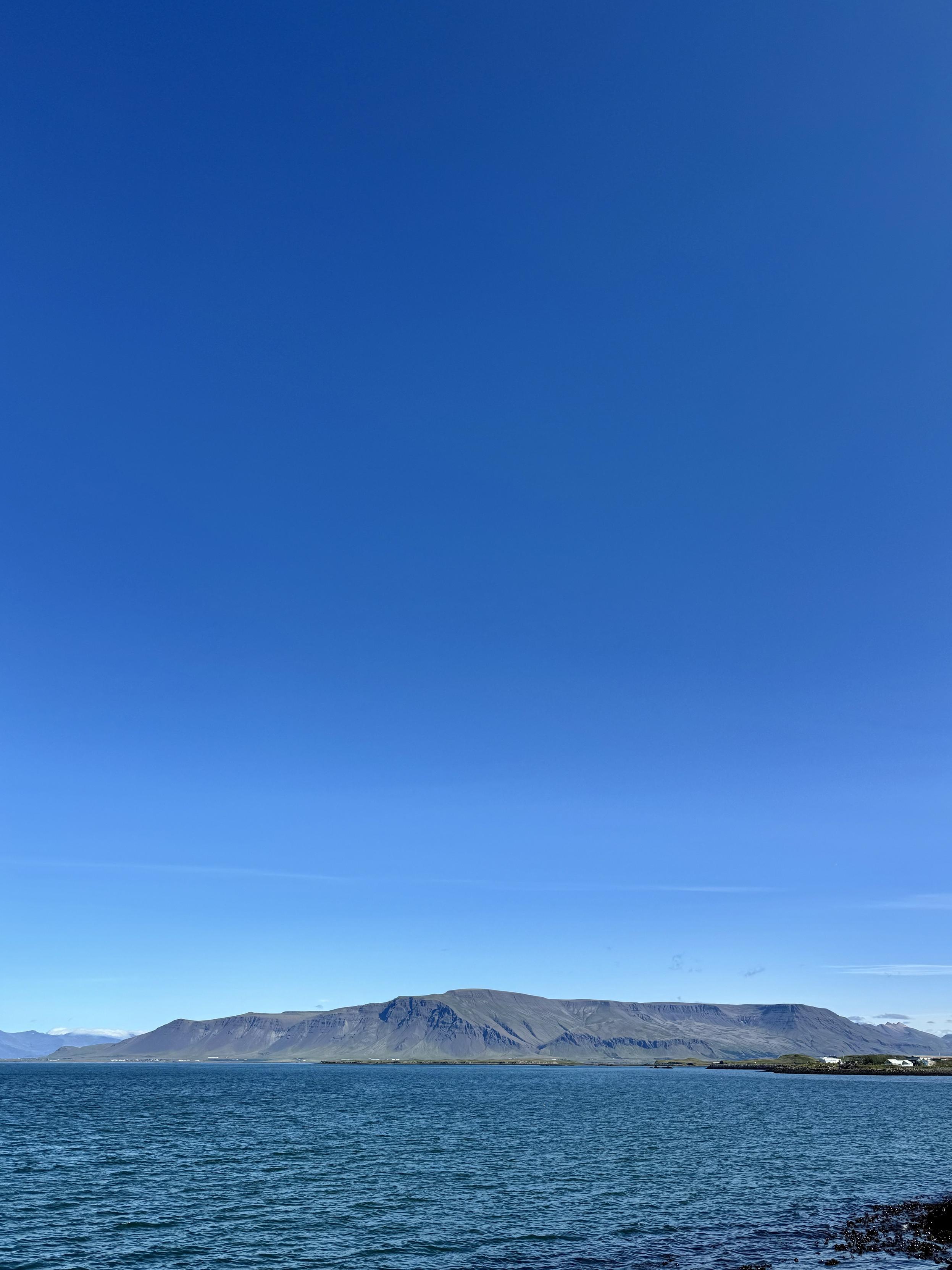 Mt. Esja seen on a beautiful blue sky day across the water