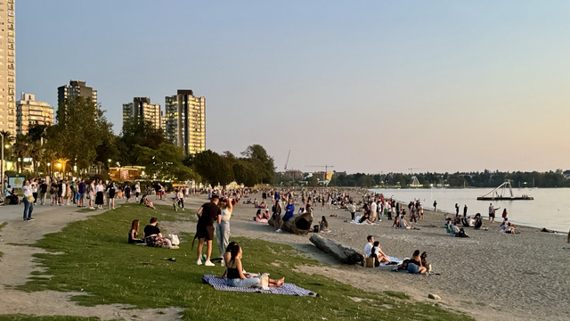 People enjoying last night’s sunset at English Bay in Vancouver BC as a period of above normal temperatures affects the region