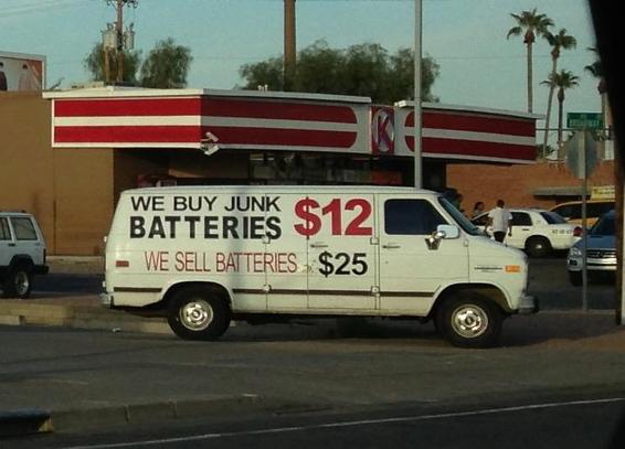 An #old #white #chevy #van with #writing on it that #says we #buy #junk #batteries $12, we #sell #batteries $25