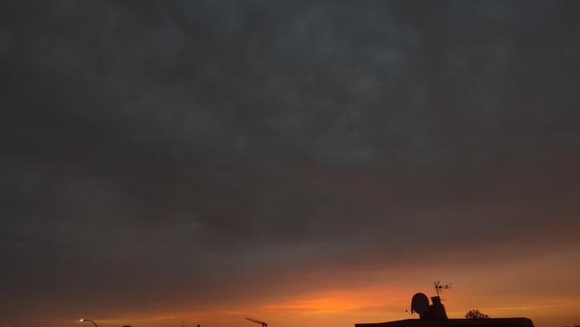 Wide angle (0.6x) landscape photo of a cloudy sunset