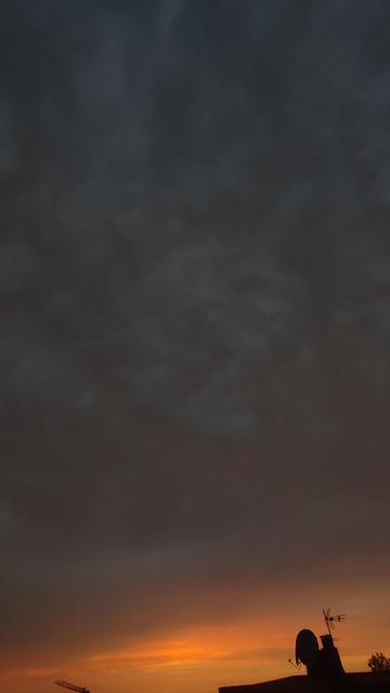 Wide angle (0.6x) portrait photo of a cloudy sunset