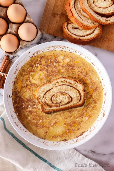 Cinnamon swirl bread dipped into egg batter mixture. 