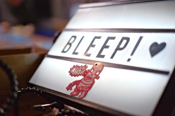 an analog sign with the inscription bleep and the illustration of a small robot