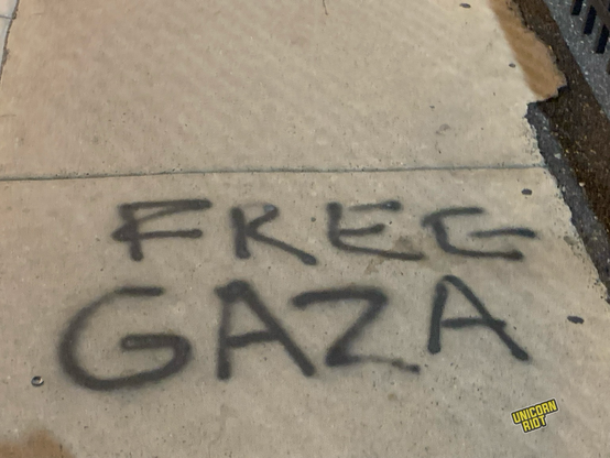 “Free Gaza” spray painted in black on a sidewalk