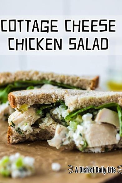A cottage cheese chicken salad sandwich cut in half on the counter. A bite has been taken from the center of the sandwich.  Text overlay says: Cottage Cheese Chicken Salad