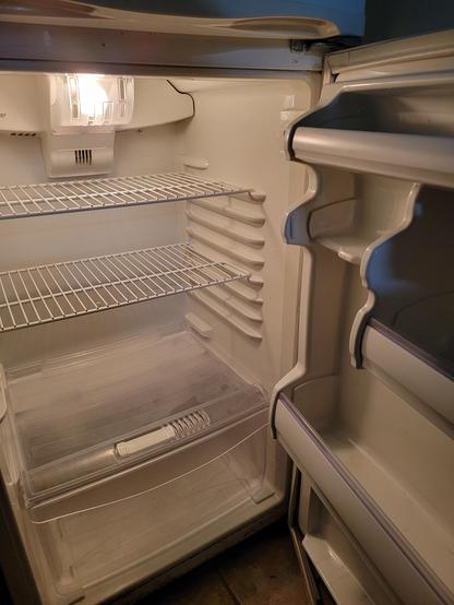 An empty interior of a refrigerator
