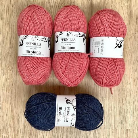 3 balls of pink yarn and 1 in blue, shown on a light wooden background.