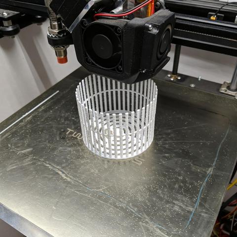 The latest version less than half way printed. The first ring that was added can be seen. There is still stringing but each column is 2 perimeters so is constructed as a single loop.