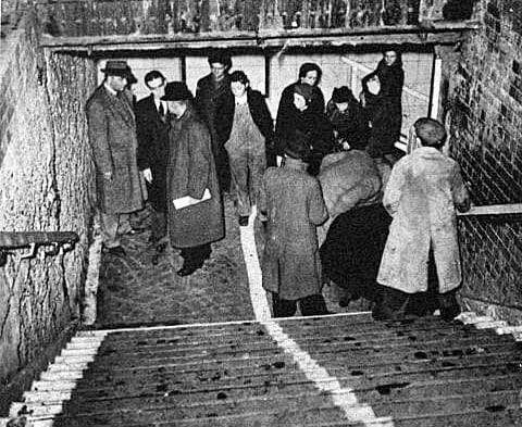 Photo 1943 inspection of the site at base of stairs where 100+ died in crush as 2,000 rushed down into Bethnal Green underground station to escape aerial bombardment of Blitz
