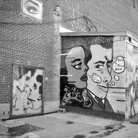 A black and white film photo. Several wall art installations convene at Paintbrush Alley in San Angelo, Texas. Sunday, September 1, 2024.