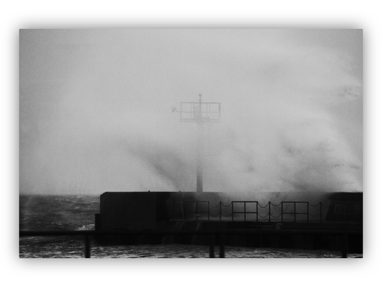 Storm. Waves crash against the breakwater.