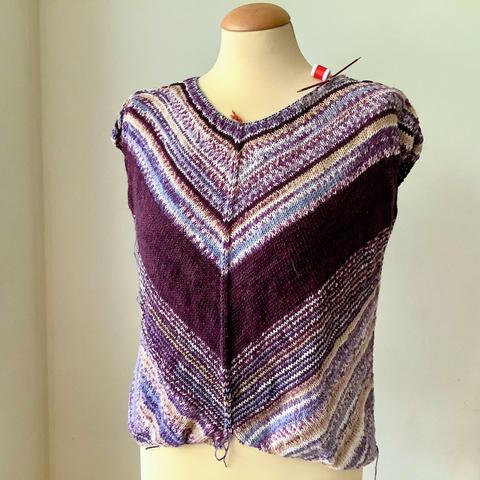 A bottom up tee being knit in purples, it's shown from the front on a mannequin.