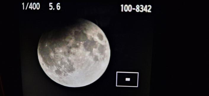 Partial lunar eclipse camera image near maximum from the Allan I Carswell Observatory at York University.  The moon is bright and round except just near one edge where a tiny 'bite' has been taken out by Earths shadow. Image credit: Sunna Withers, AICO 