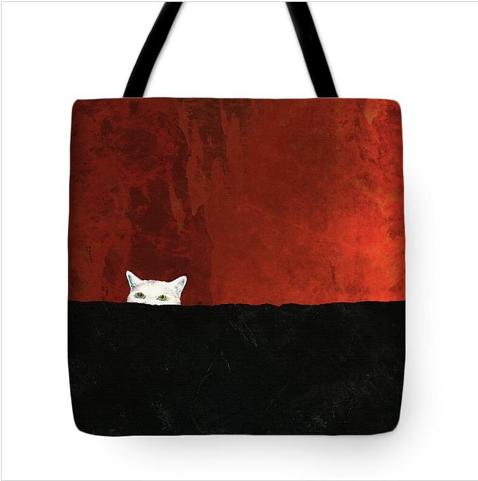 Tote bag in orange red and black with a white cat with green eyes by artist Sharon Cummings.