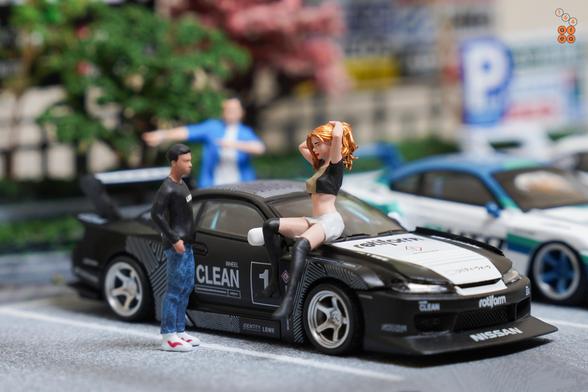 A guy talk to a sexy girl who sit on a hood of LB-Super Silhouette, Nissan Silvia S15 by Time Micro in 1:64 scale with 1:64 figures on AREA 164