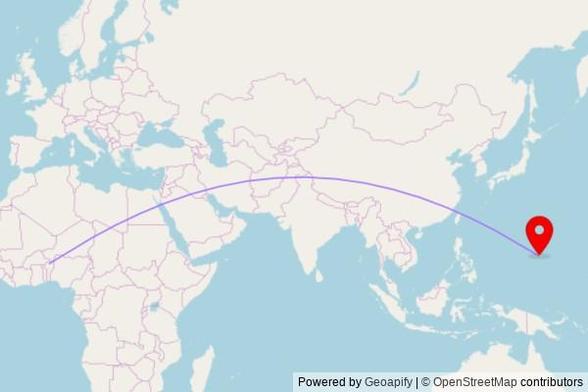 A map showing the great circle route from Kokiborou in Benin to a map pin at Saint Anthony Catholic Church, Gumayuos Street, Tamuning, GU 96911, United States of America