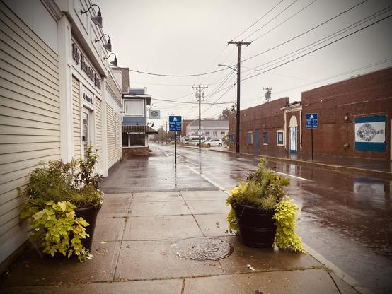 The photo depicts a rainy street in Hyannis, Massachusetts. 