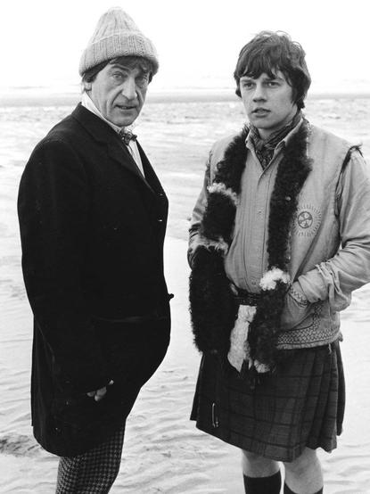 Publicity photo of Patrick Troughton and Frazer Hines as the Doctor and Jamie, standing on a beach from the Doctor Who story, 'Fury from the Deep.' 