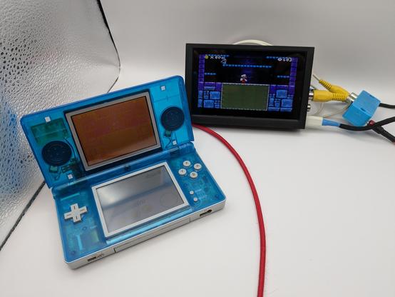 Ds lite displaying the top screen on a backup camera screen in a light box