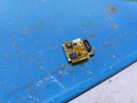 A flex PCB soldered to a DS Lite wifi chip on a blue rubber mat