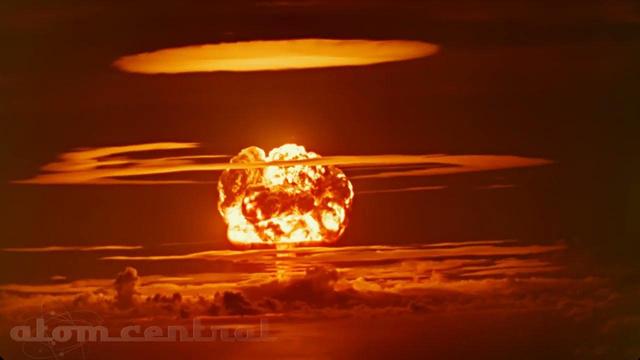 Photograph taken during the Redwing Tewa test of a three-stage thermonuclear (fusion) device with a five megaton yield on 21 Jul 1956 at Bikini Atoll.

The image, taken from the thumbnail of the video, "NEW Redwing Tewa 4K UHD Restoration" on the AtomCentral YouTube channel, shows the rising fireball illuminating surrounding rings of "clouds"and pulverised ground in yellow-orange glow.