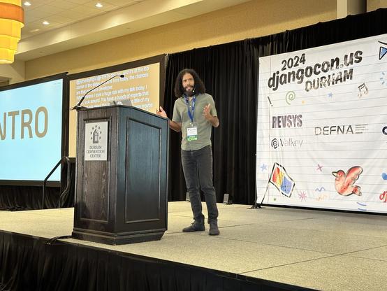 Mario Munoz on stage at DjangoCon US 2024 telling his story.