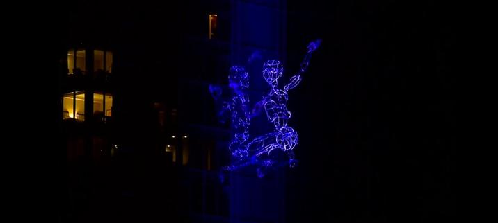 'David', a 35-foot tall 200-pound puppet, climbing the glass outer walls of the Amway Grand Hotel, in Grand Rapids, Michigan