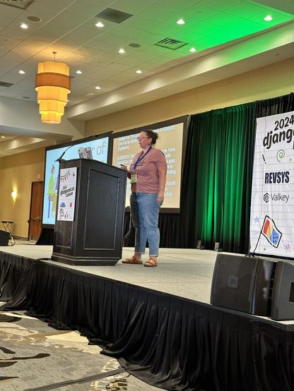 Elizabeth Garrett Christensen on stage talking about Postgres internals at DjangoCon US.