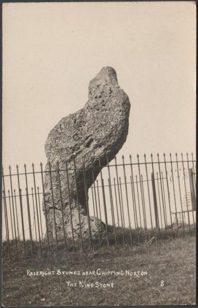 A vintage photographic postcard showing the King Stone in Warwickshire, standng just across the border from the King's Men stone circle and the Whispering Knights which together comprise the Rollright Stones at Little Rollright near Chipping Norton in Oxfordshire. The oolitic limestone menhir is about 2.5m or 8ft tall and stands within a fence.